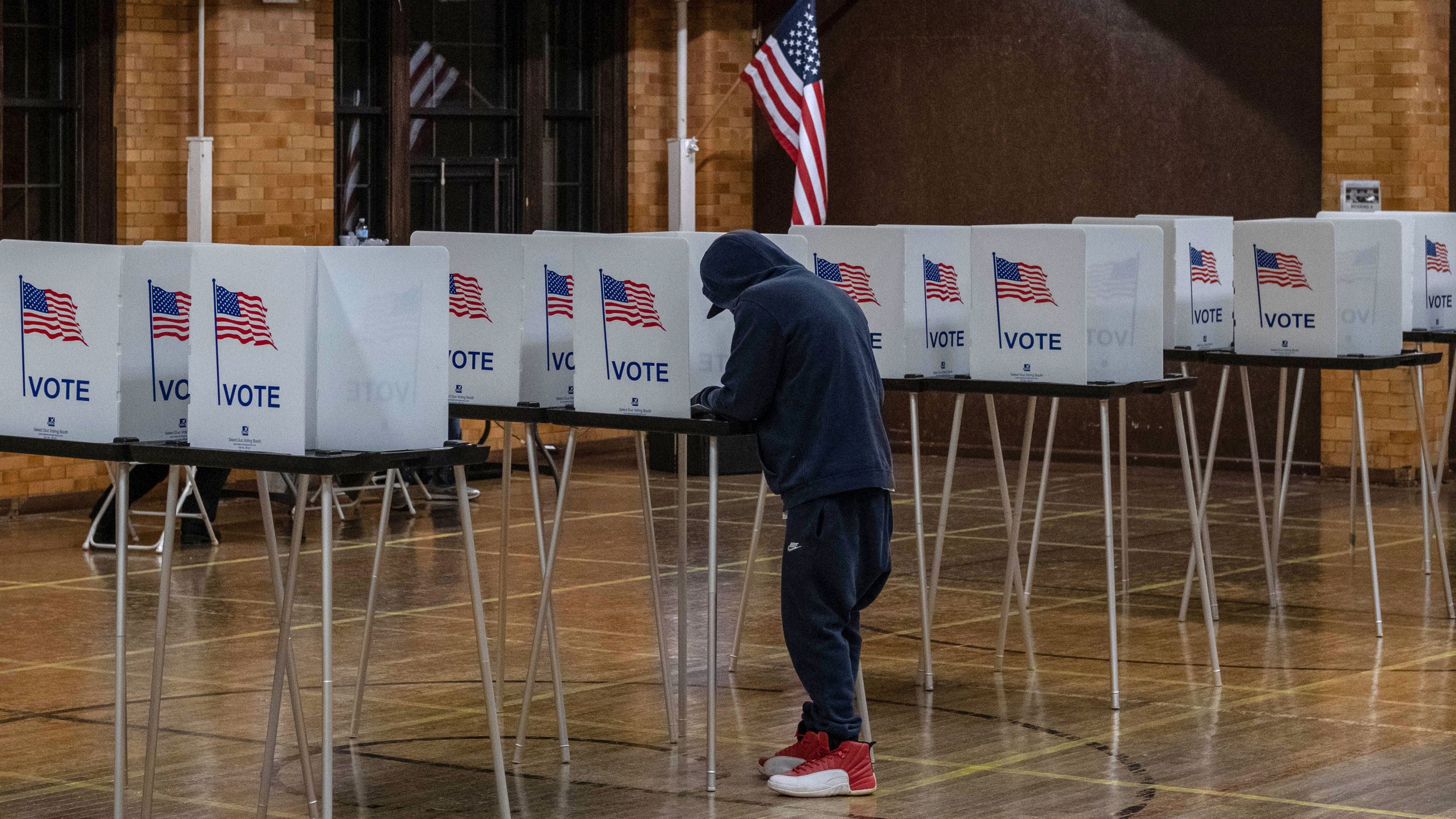 A resident casts his vote on November 3, 2020, at Berston Fieldhouse in Flint, Michigan.