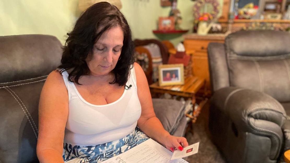 Michele Preissler thumbs through her husband's funeral book.