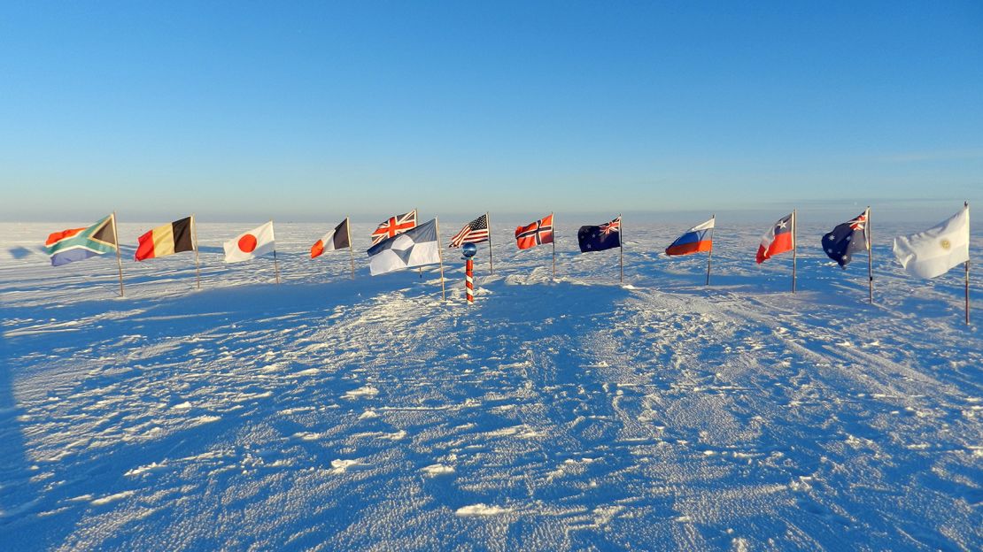 The True South flag flies alongside  the flags of the original 12 Antarctic Treaty Signatories at the ceremonial South Pole.