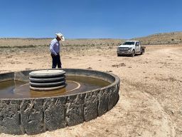 Cattle Rancher T.J. Atkin checks on one of his troughs which provide drinking water for his cows.