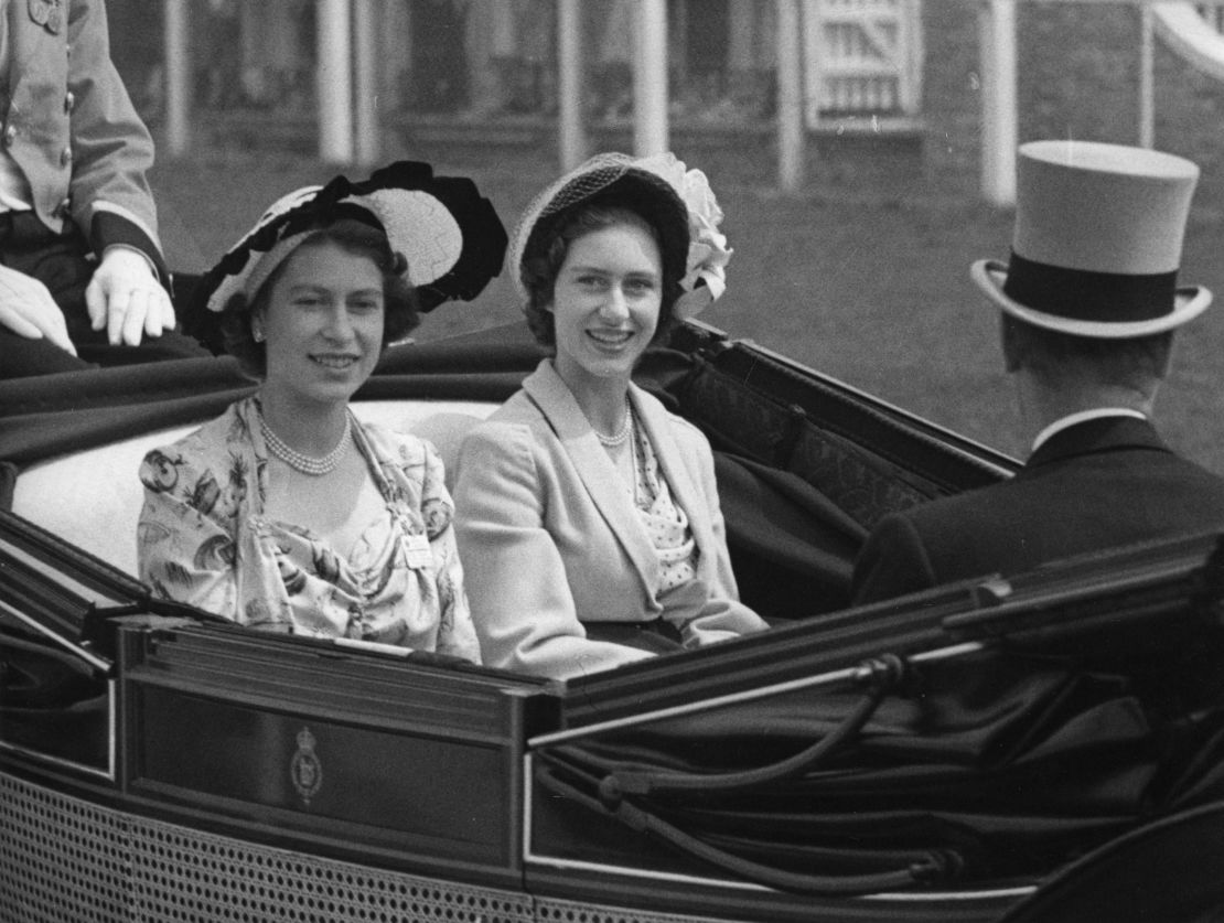 Then-Princess Elizabeth, left, and her sister, Princess Margaret, arrive at the grandstand at Royal Ascot in 1949. 