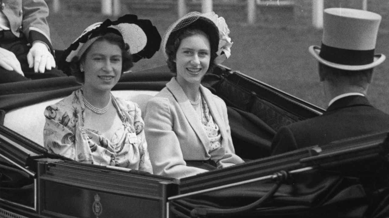 Then-Princess Elizabeth, left, and her sister, Princess Margaret, arrive at the grandstand at Royal Ascot in 1949. 