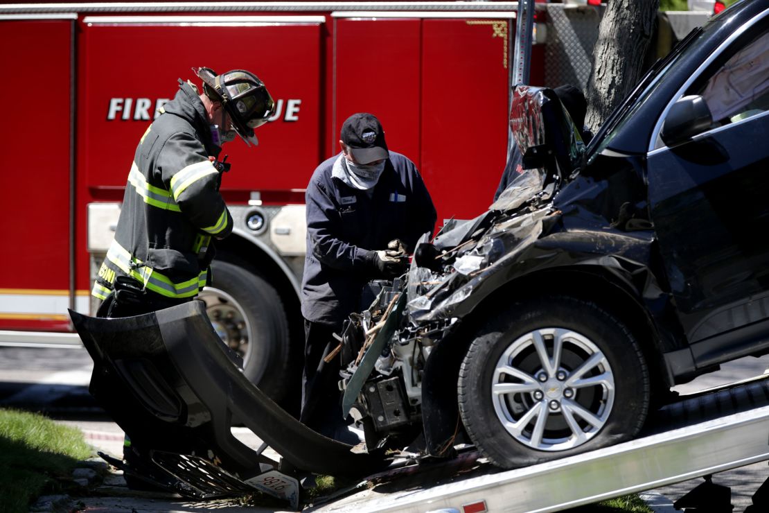 A car  is towed away after crashing into a home in Quincy, Massachusetts, on May 13, 2020. 