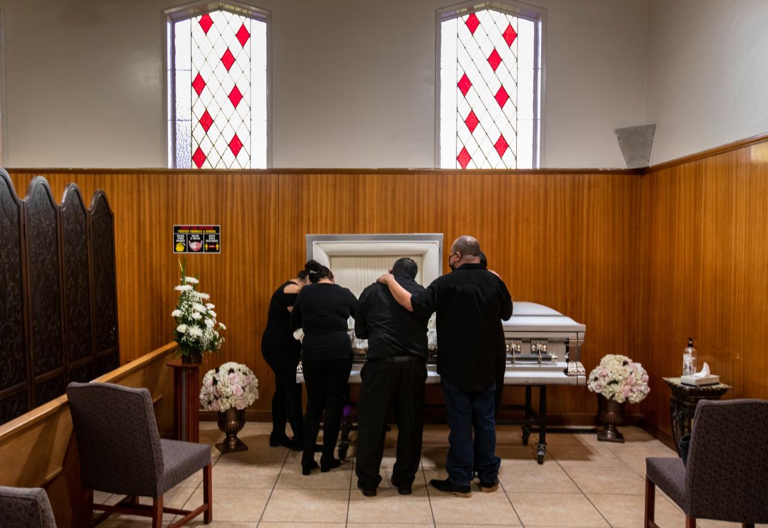 Family members gather to mourn a lost relative at the Continental Funeral Home on December 20, 2020 in East Los Angeles.