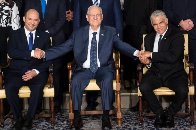 Israeli President Reuven Rivlin, center, poses with Israeli Prime Minister Naftali Bennett, left, and Foreign Minister Yair Lapid as the new Israeli government poses for a group photo in Jerusalem on Monday, June 14. Bennett was sworn in Sunday after <a href="https://www.cnn.com/2021/06/13/middleeast/israel-knesset-vote-prime-minister-intl/index.html" target="_blank">winning a confidence vote</a> with the narrowest of margins. His victory ended a 12-year grip on power by former prime minister <a href="http://www.cnn.com/2021/05/31/middleeast/gallery/benjamin-netanyahu/index.html" target="_blank">Benjamin Netanyahu,</a> the country's longest-serving leader. 