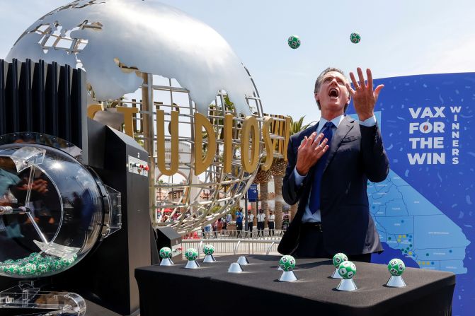 California Gov. Gavin Newsom juggles during the "Vax for the Win" lottery drawing on Tuesday, June 15. The lottery is an incentive program designed to entice people to get vaccinated against Covid-19. The latest drawing picked 10 Californians to receive $1.5 million each.