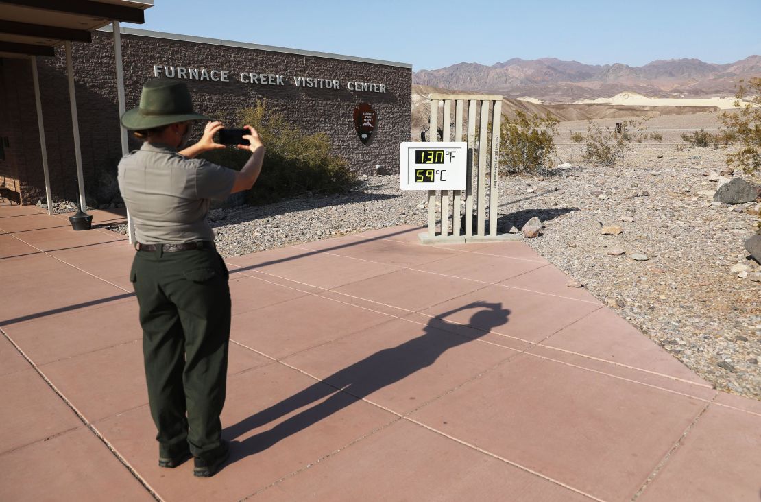 A park ranger takes a picture of an unofficial thermometer at Furnace Creek Visitor Center in California's Death Valley National Park on August 17, 2020, a day after the temperature had reached 130 degrees.