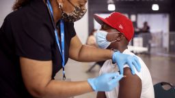 Yaw Kesse gets a COVID-19 vaccine from Alexis Watts at Guaranteed Rate Field before the start of the Chicago White Sox game against the Toronto Blue Jays on June 08, 2021 in Chicago, Illinois. Fans who received the vaccine were offered two free tickets to the game or received a voucher good for two tickets to a future game. 
