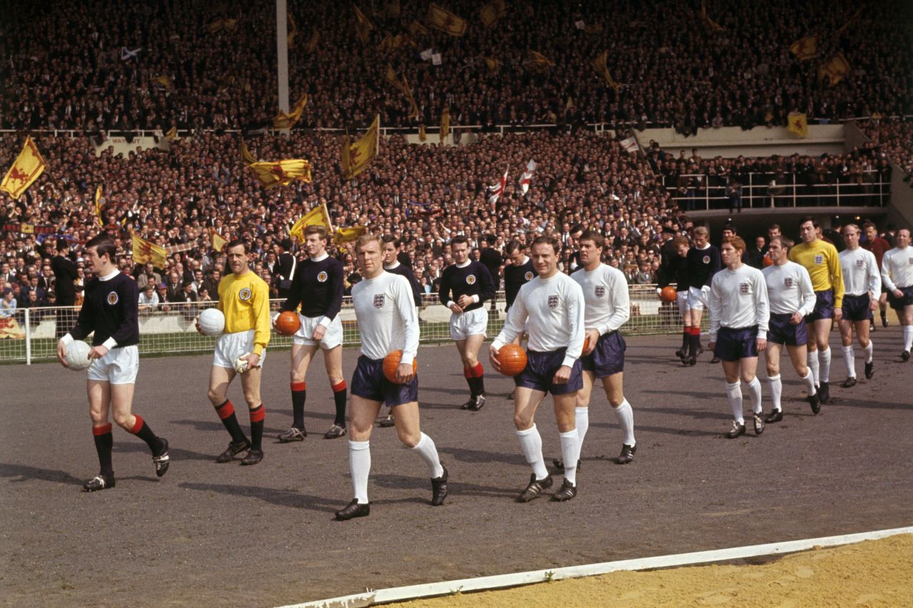 April 15 1967: Scotland captain John Greig and England captain Bobby Moore lead out their teams ahead of kick off. 