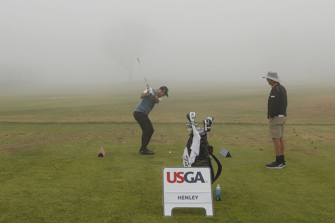 Henley plays on the practice range during a fog-delayed first round of the 2021 U.S. Open.