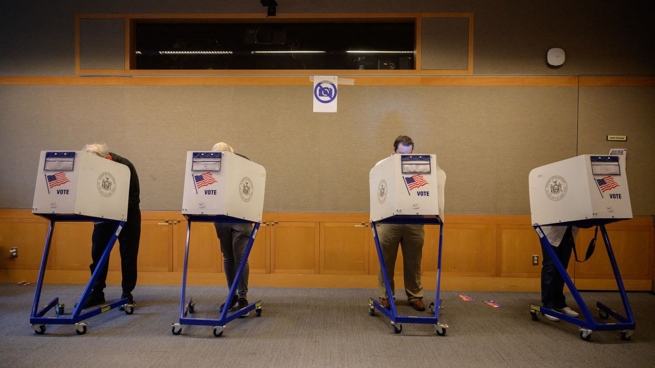 Voters stand in booths at a voting station at the Metropolitan Museum of Art (MET) during the mayoral election process in New York on June 12, 2021.