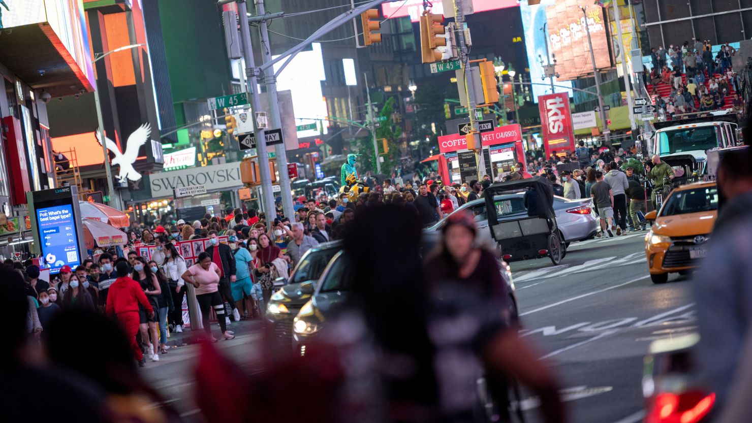 Crowds of people, mostly without masks, fill New York's Times Square on June 12. New York is among many states to pull back on Covid-19 restrictions in recent weeks.