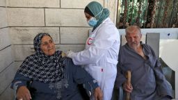 A Palestinian member of a health ministry mobile unit vaccinates elderly Palestinians  against the COVID-19 coronavirus, in the village of Dura near Hebron in the occupied West Bank, on June 9, 2021. (Photo by HAZEM BADER / AFP) (Photo by HAZEM BADER/AFP via Getty Images)