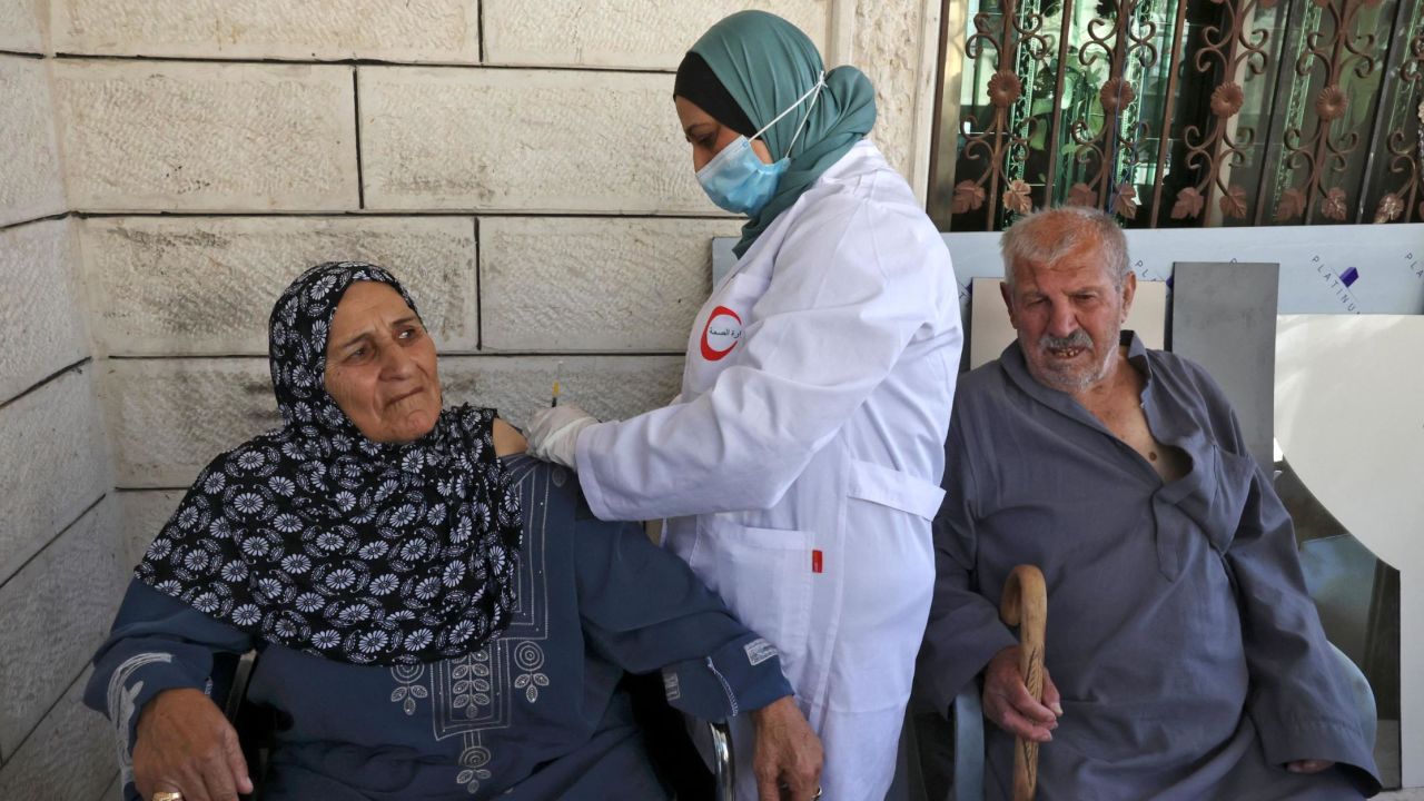 Elderly Palestinians are vaccinated against Covid-19 in the village of Dura near Hebron in the West Bank on June 9.