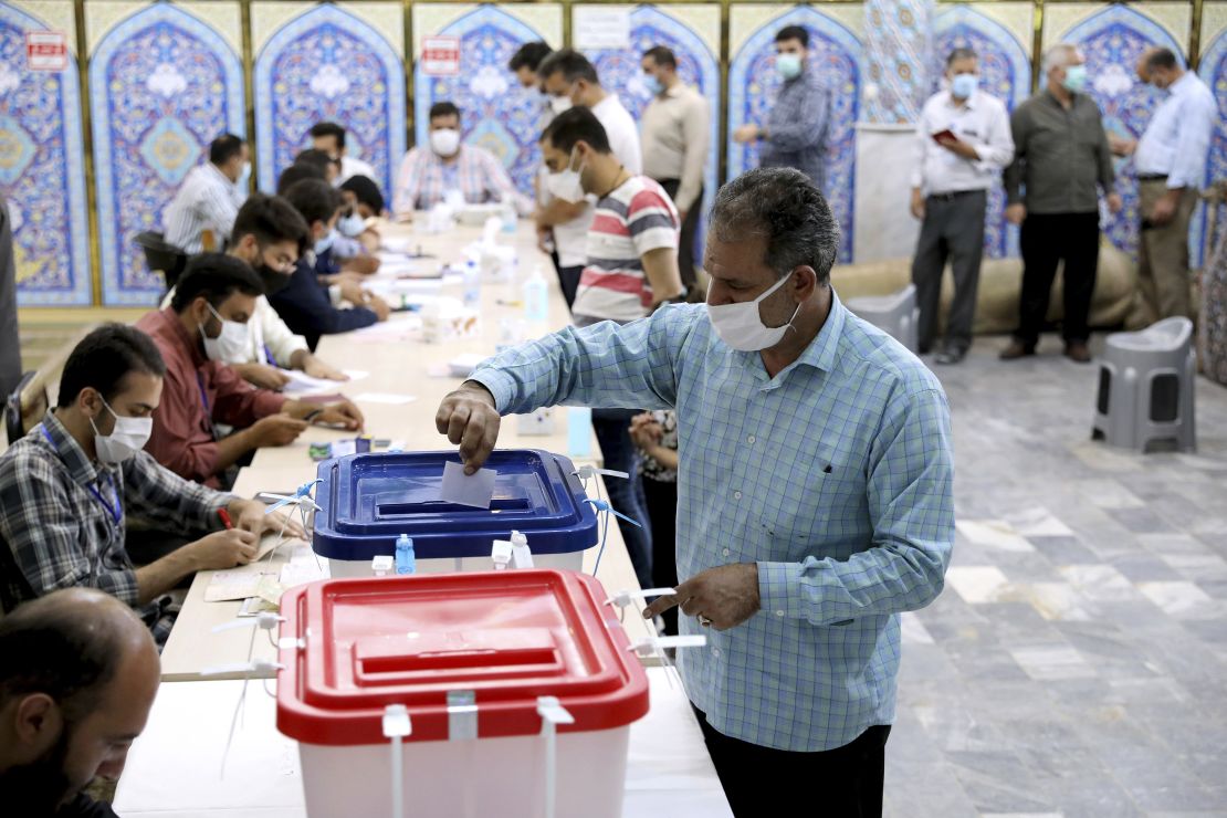 A voter casts his ballot at a polling station in Tehran on Friday.