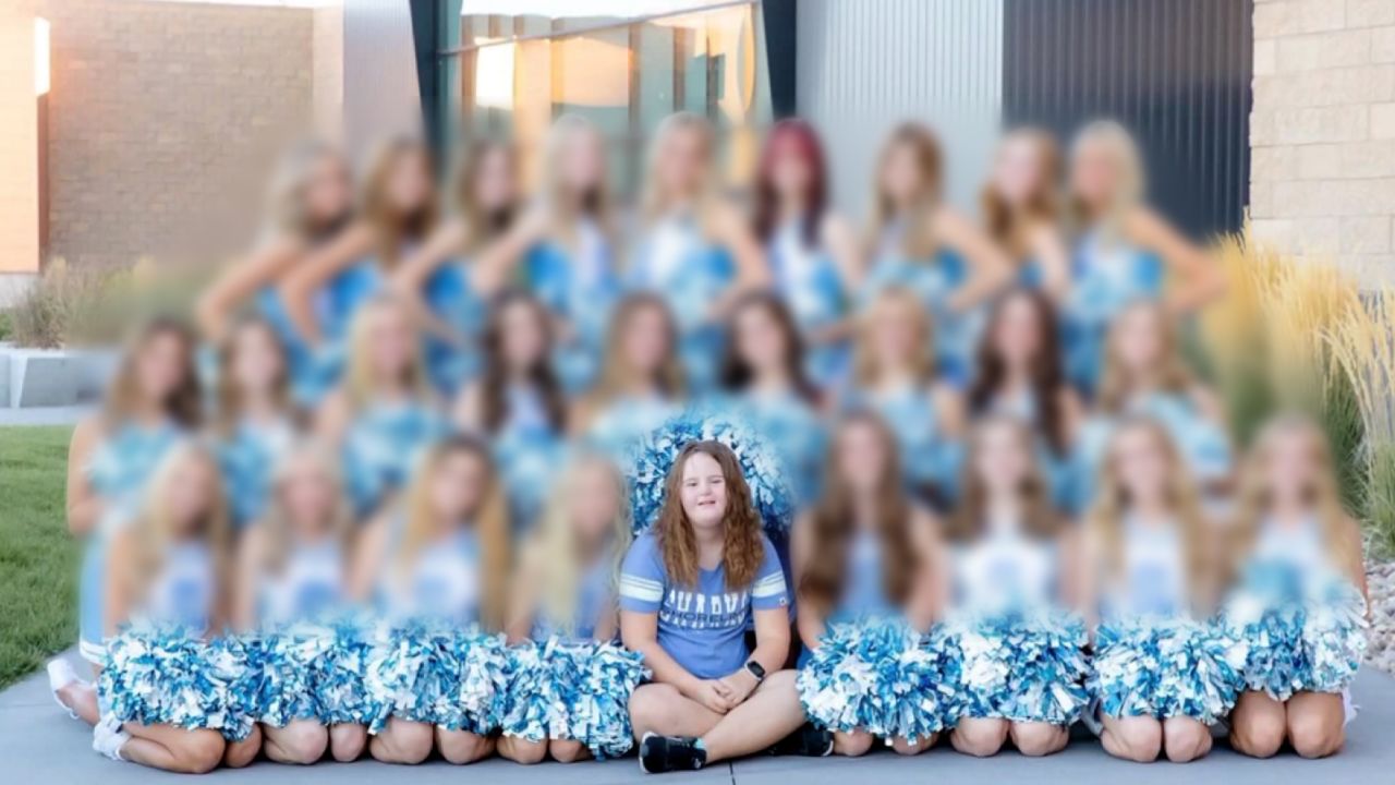 Morgyn Arnold, front row center, poses in a cheerleading portrait that was not used in her school's yearbook. CNN intentionally blurred the image due to the age of the other subjects in the image.

