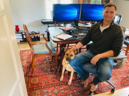 Robert Allenby in his home office with his dog Anna in San Diego, California.