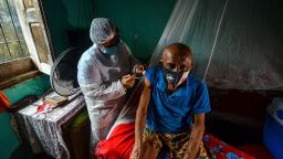 TOPSHOT - A man is vaccinated against COVID by a health worker in a remote area of Moju, Para state, Brazil on April 16, 2021. - Brazil is the country with the second-highest death toll in the world, with more than 365,000 fatalities -- 66,000 in March alone. Observers believe the number is an undercount. Last week, the country of 212 million people recorded a new record of 4,000 deaths in 24 hours. (Photo by Joao Paulo Guimaraes / AFP) (Photo by JOAO PAULO GUIMARAES/AFP via Getty Images)