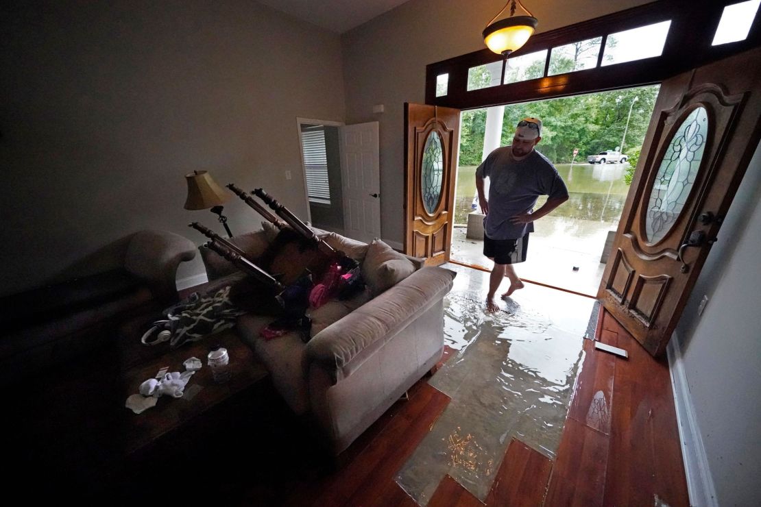 Danny Gonzales walks in his flooded house Saturday after Claudette passed through Slidell, Lousiana.
