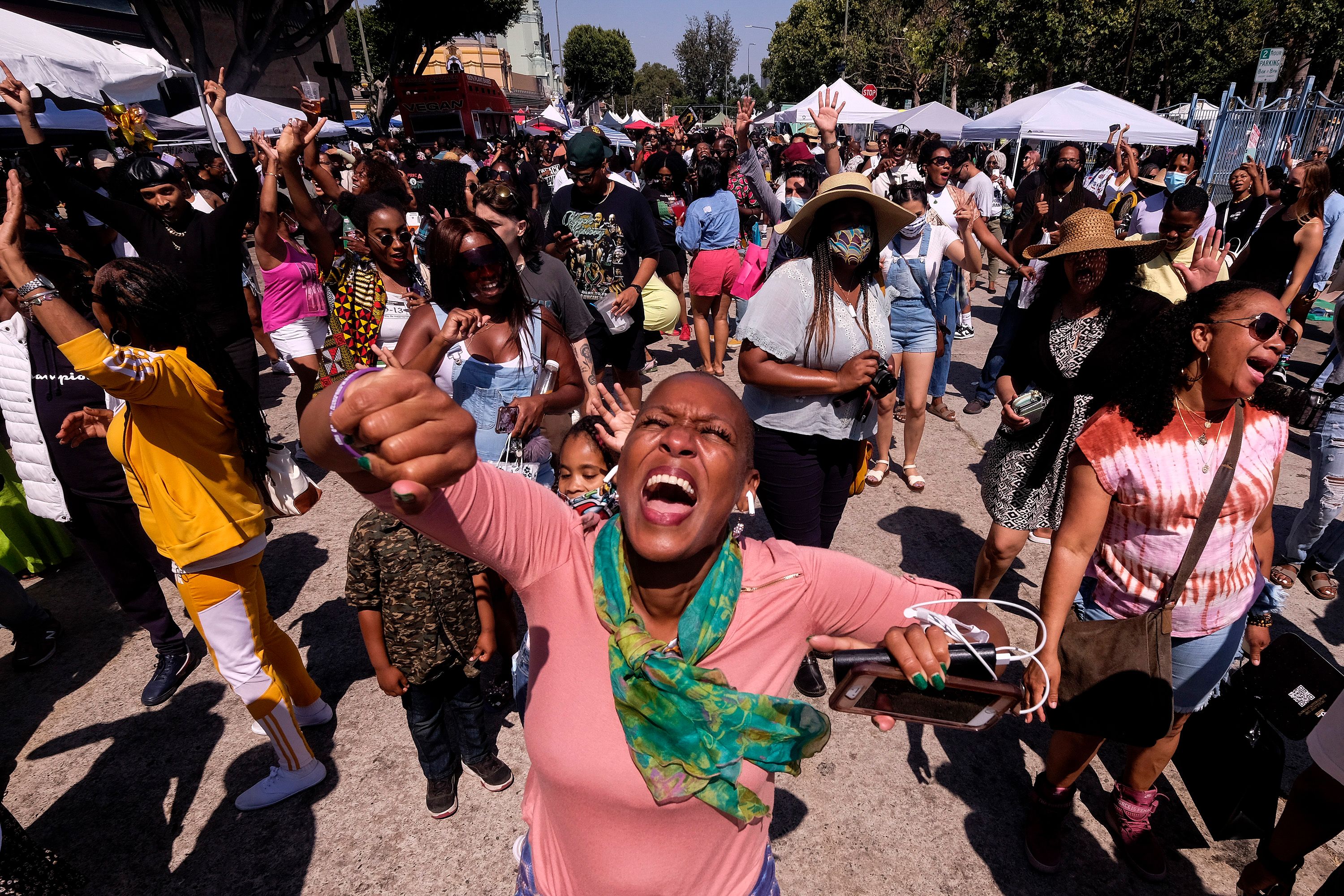 People dance during a Juneteenth commemoration at Leimert Park Plaza on Saturday, June 19, in Los Angeles.