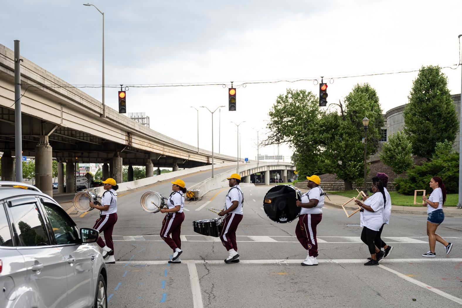 River City Drum Corp crosses the street during a march for the Juneteenth commencement in Louisville, Kentucky. 
