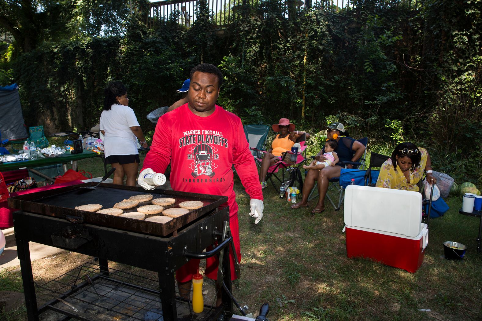Darian Anderson grills for his family and friends as they celebrate Juneteenth at River's Den Resort in New Braunfels, Texas.