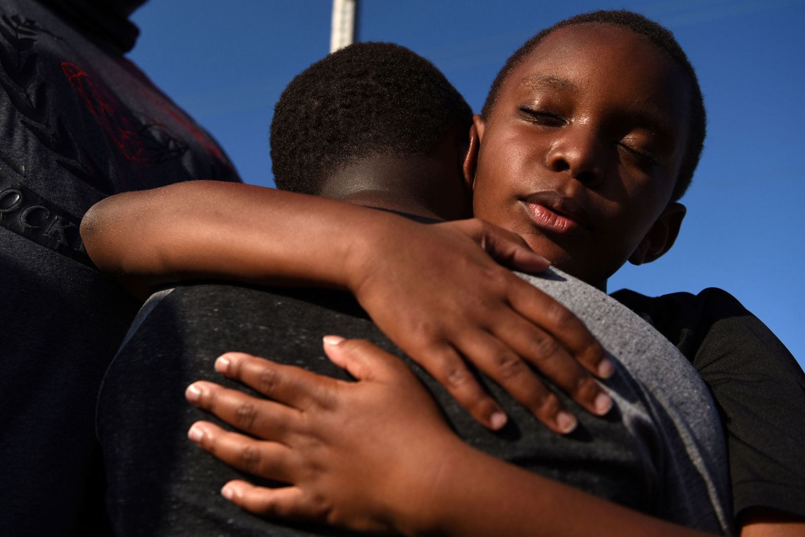 Brothers Brody and Braeden Maxey share a hug during a reenactment to celebrate Juneteenth in Galveston.