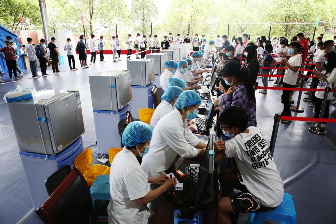 Doctors give COVID-19 vaccine to high school seniors at a temporary vaccination site in Chongqing, China on June 10.