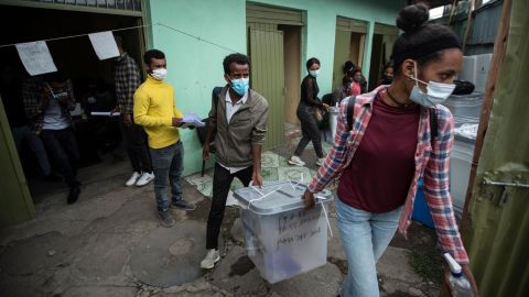 Electoral workers carry ballot boxes in the rain from a distribution center in Addis Ababa, Ethiopia on June 20.