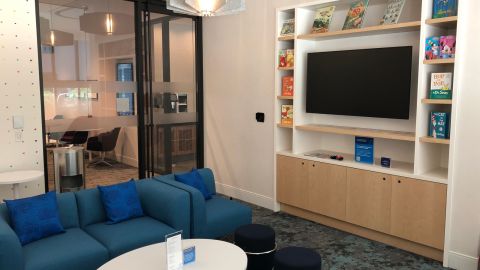 The lounge's multipurpose room features age-appropriate books for children.