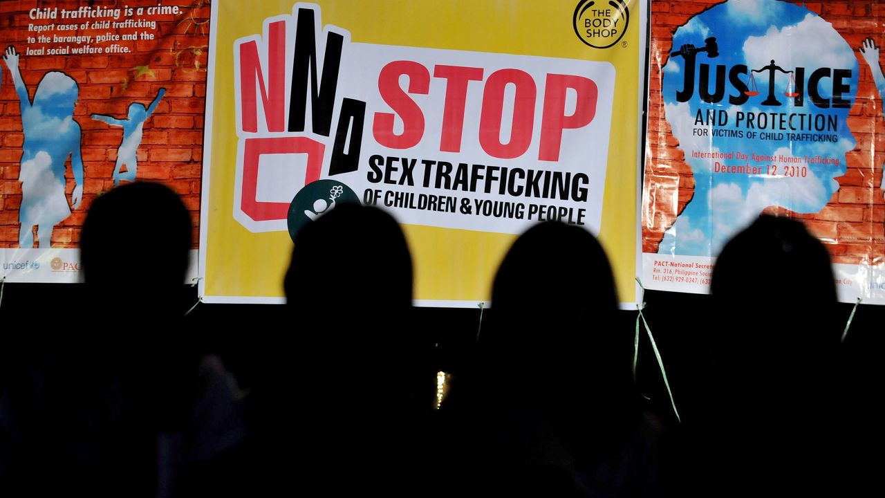 Children in front of anti-sex trafficking posters in Quezon, the Philippines, in 2010.