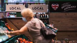 A customer selects a piece of fresh fruit inside a Morrisons supermarket, operated by Wm Morrison Supermarkets Plc, in Saint Ives, U.K., on Wednesday, Aug. 19, 2020. 