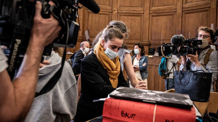 Accused Valerie Bacot (C/yellow scarf) arrives flanked by her family and surrounded by journalists the Chalon-sur-Saone Courthouse, on June 21, 2021, central-eastern France, prior to the opening hearing of her trial on charges of murdering her stepfather turned husband, who she claimed abused her since she was 12. (Photo by JEFF PACHOUD / AFP) (Photo by JEFF PACHOUD/AFP via Getty Images)