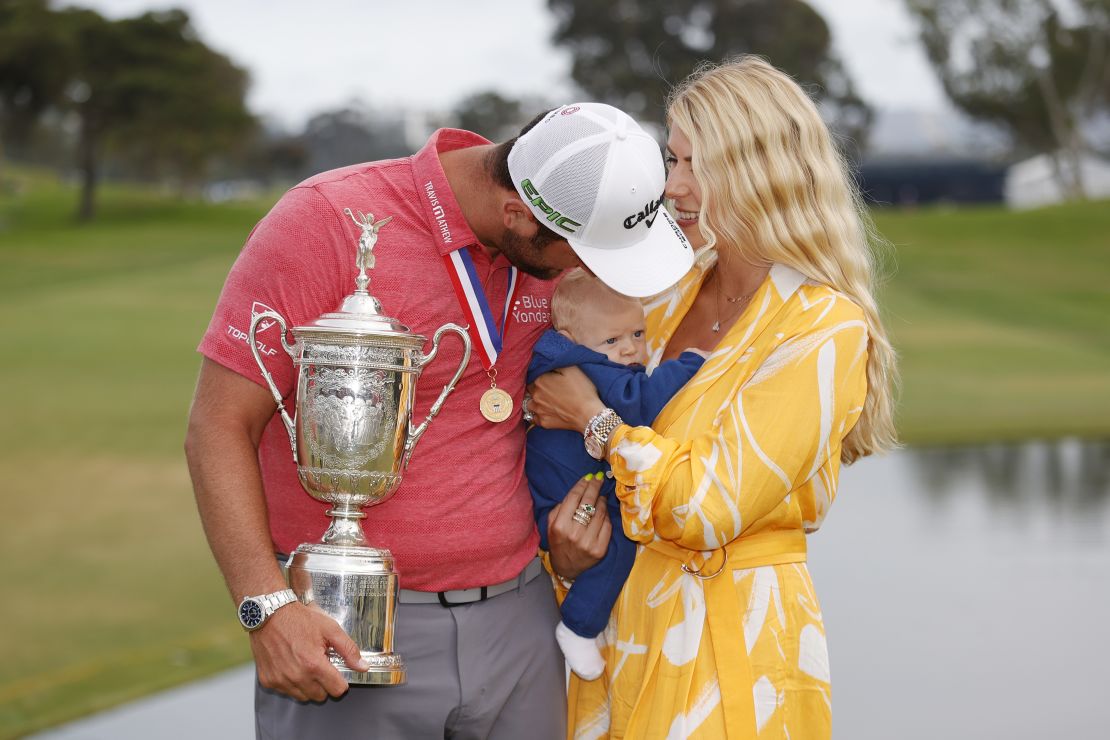 Rahm celebrates with the trophy alongside his wife, Kelley, and son, Kepa, after winning the 2021 US Open.
