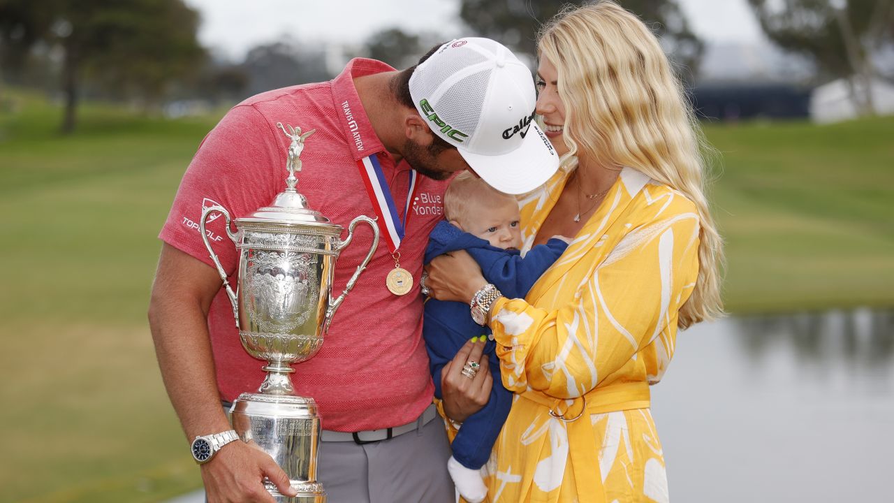 Rahm celebrates with the trophy alongside his wife, Kelley, and son, Kepa, after winning the 2021 US Open.