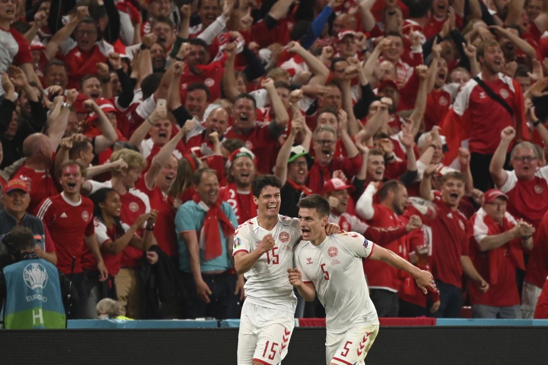 Denmark's Joakim Maehle, right, celebrates after scoring his side's fourth goal against Russia.