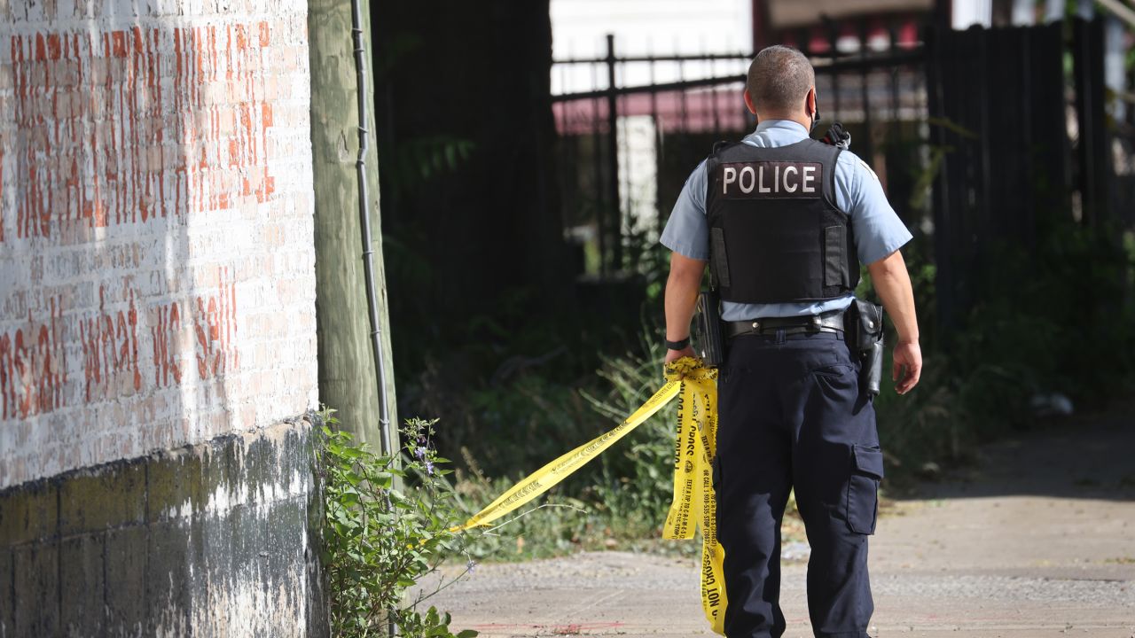 CHICAGO, ILLINOIS - JUNE 15: Police secure the scene of a shooting on June 15, 2021 in the Englewood neighborhood of Chicago, Illinois. Four people were killed at a home during an early-morning shooting and four others who were injured were transported to the hospital. (Photo by Scott Olson/Getty Images)