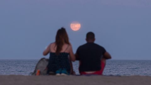 Last year's strawberry moon is seen from Malaga, Spain.