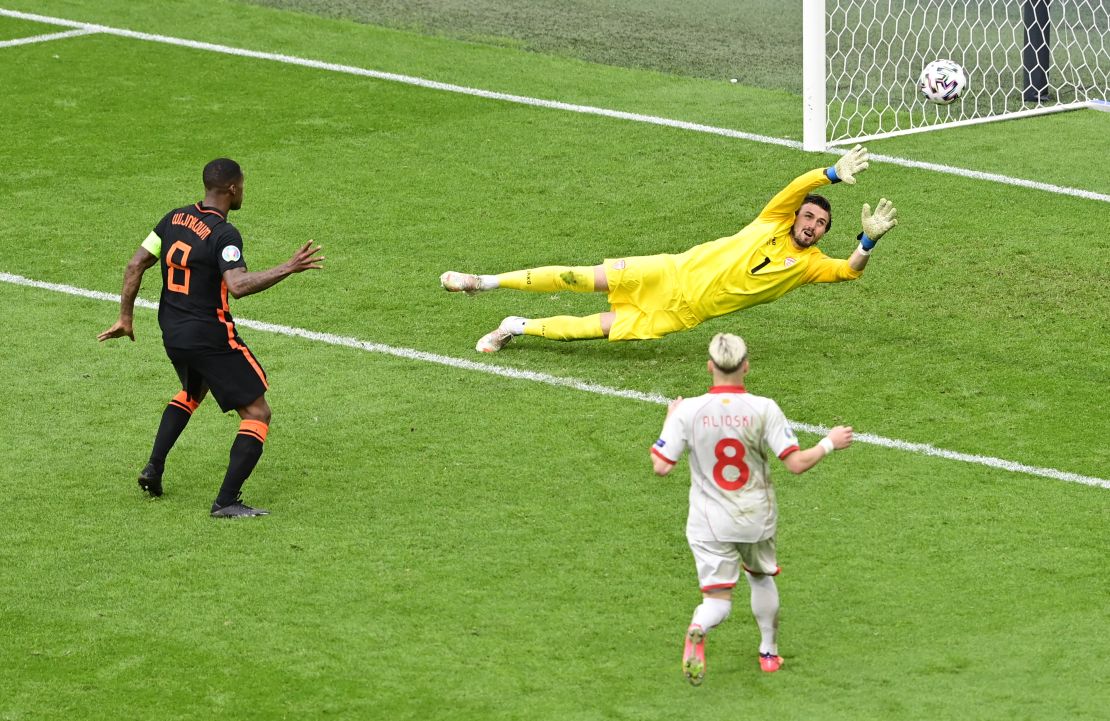 Gini Wijnaldum of the Netherlands scores their side's third goal past Stole Dimitrievski of North Macedonia during their Euro 2020 Group C match between North Macedonia in Amsterdam.