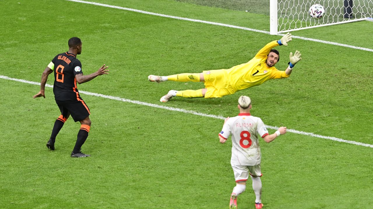 Gini Wijnaldum of the Netherlands scores their side's third goal past Stole Dimitrievski of North Macedonia during their Euro 2020 Group C match between North Macedonia in Amsterdam.