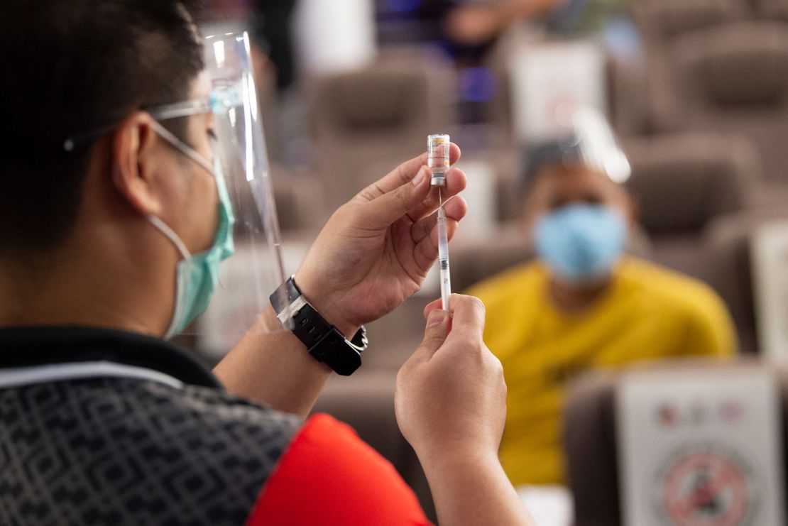 A health worker prepares a vial of the Sinovac coronavirus vaccine at a vaccination centre in Taguig City, Manila, on June 14.