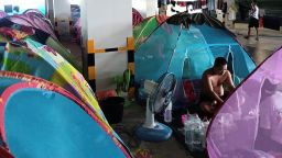 Migrant workers from Myanmar pass their time near their mosquito net tents at Cal-Comp Electronics factory while under quarantine, Phetchaburi, Thailand June 8, 2021. Picture taken June 8, 2021. REUTERS/Stringer NO RESALES. NO ARCHIVE.