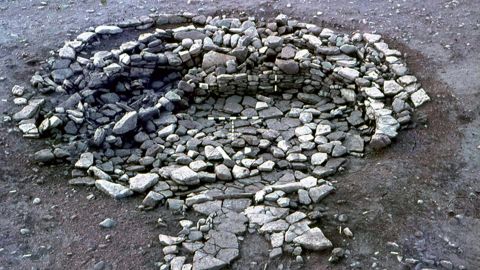 Objects including bone spoons, quernstones and gaming pieces were incorporated into the walls of this Iron Age roundhouse at Broxmouth, Scotland.