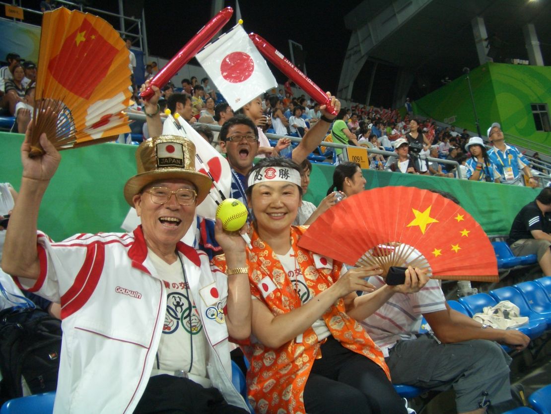Ishikawa (right) sits with Naotoshi Yamada, aka "Uncle Olympics," at the Beijing Games in 2008.