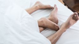 03 couples feet in bed STOCK