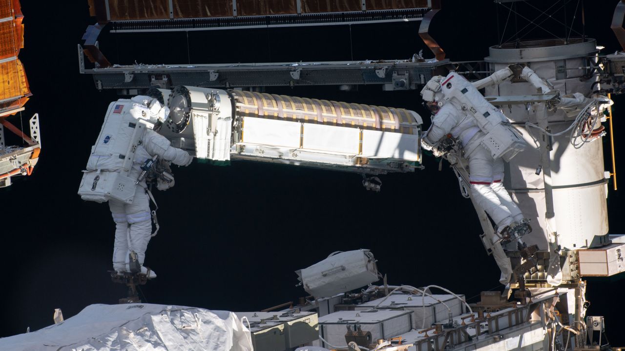 Kimbrough and Pesquet are shown working with one of the rolled up arrays.