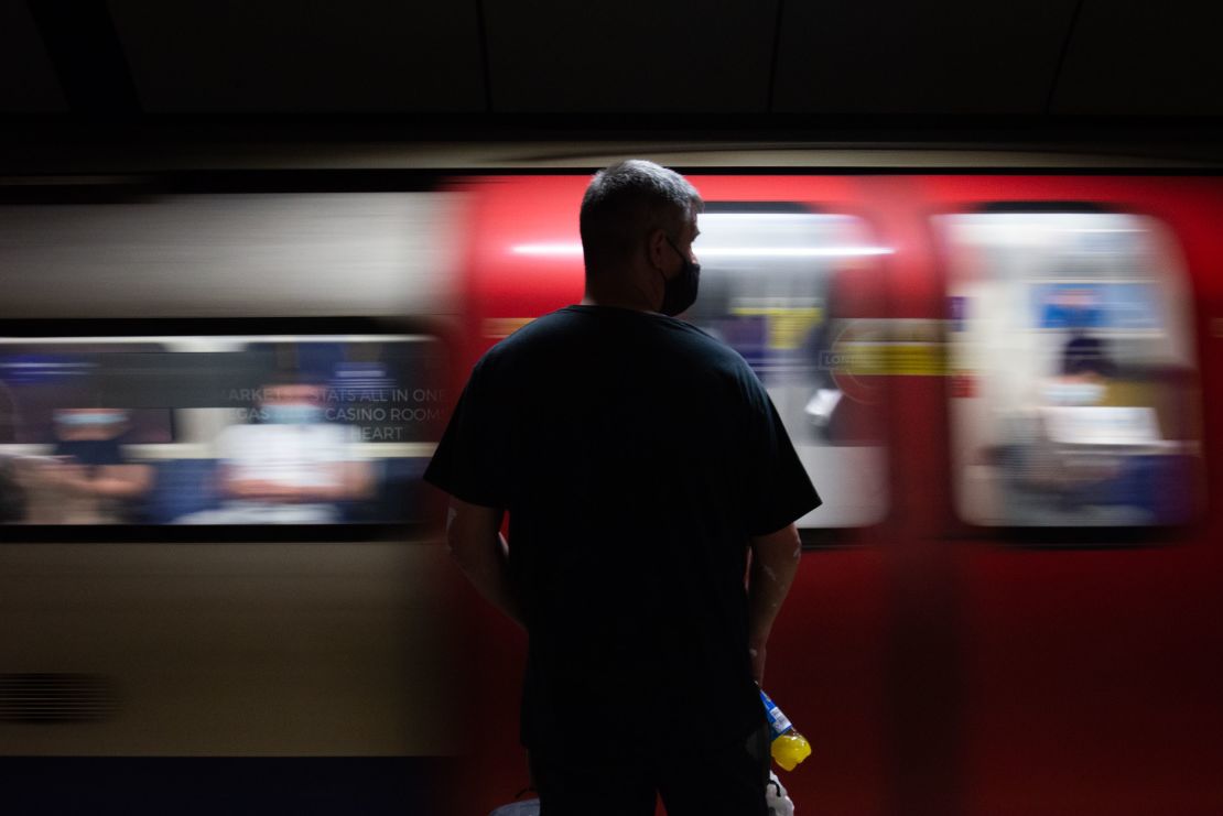 A commuter waits for a train at London Bridge Station. Laws on social distancing and mask wearing look set to be lifted later this month.
