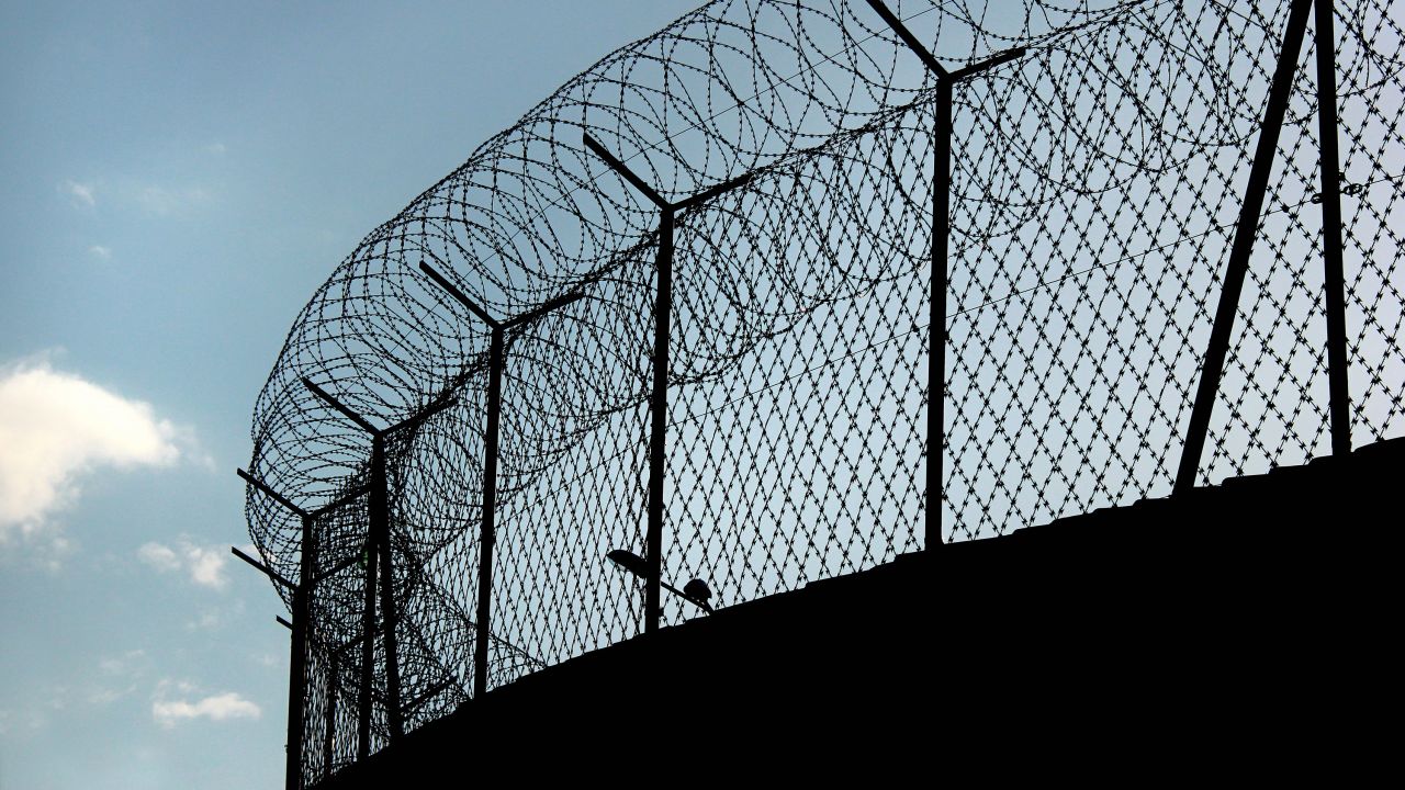 barbed wire prison fence STOCK