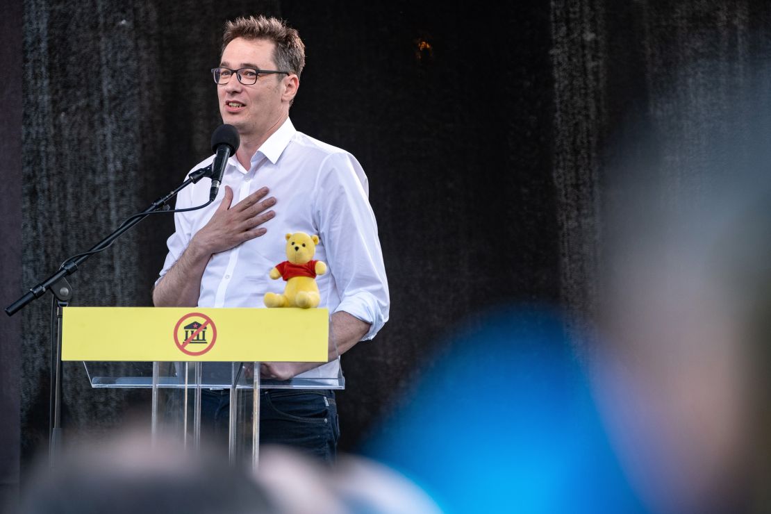 Budapest Mayor Gergely Karacsony, adresses protesters. The Winnie the Pooh toy is a reference to Chinese leader Xi Jinping, who critics say bears a resemblance to the character.
