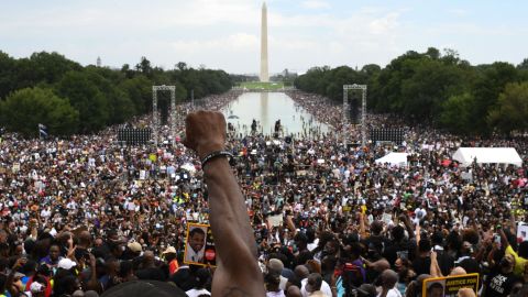 A participant raises his first during the "Commitment March: Get Your Knee Off Our Necks" protest against racism and police brutality on August 28, 2020, at the Lincoln Memorial in Washington, DC. 